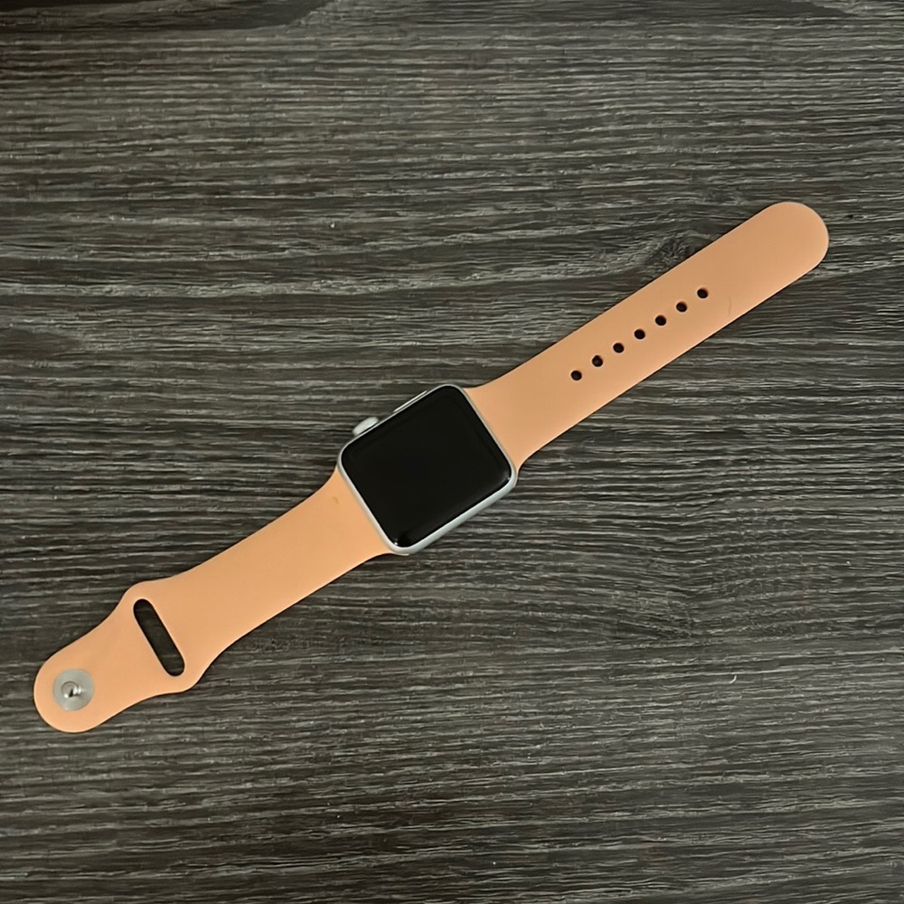 silver series 3 apple watch with small coral bands